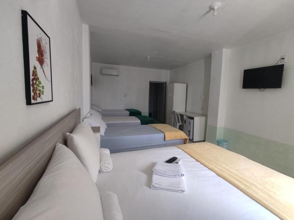 Room with several beds at Amazônia Praia Hotel